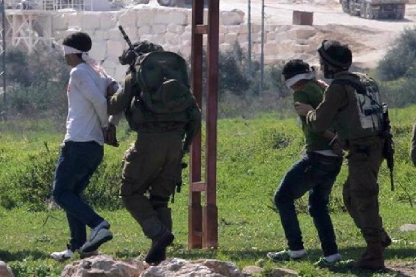 Israeli occupation forces detaining Palestinians in the occupied territories.